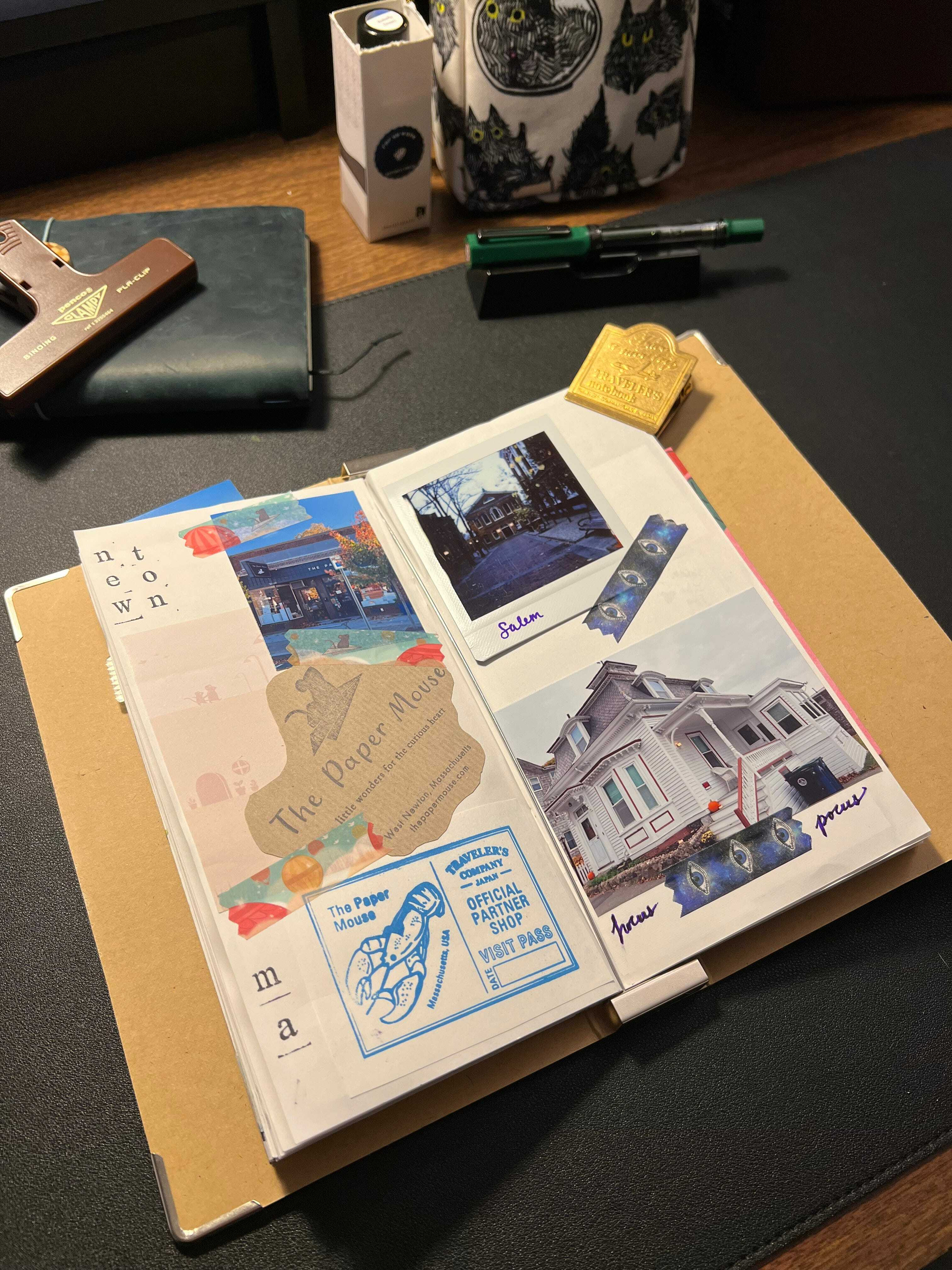 Auto-generated description: A scrapbook page with photos, a ticket stub, and decorative stickers lies open on a desk.